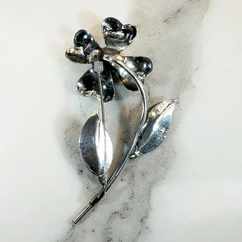 Playful Silver Flower Brooch with Amethyst Pistil